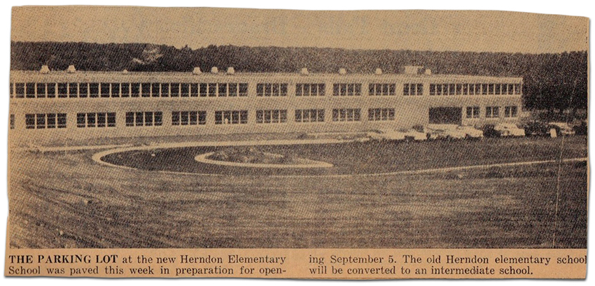 Photograph of a newspaper article featuring a picture of Herndon Elementary School on Dranesville Road. The caption reads: The parking lot at the new Herndon Elementary School was paved this week in preparation for opening September 5. The old Herndon elementary school will be converted to an intermediate school.