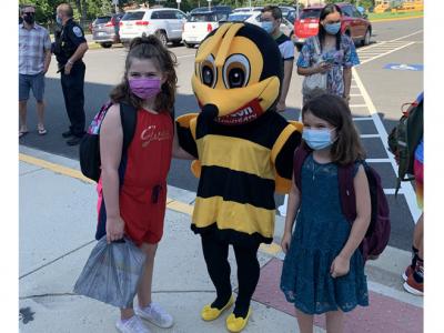 Buzzy Bee greets students on the first day of school.