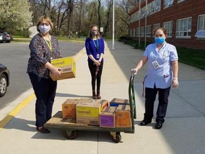 Thank you to Lisa King (center), a member specialist, for delivering boxes of Girl Scout cookies for our teachers!